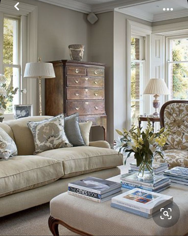 a living room filled with furniture and lots of windows