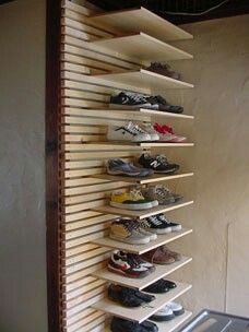 there are many pairs of shoes on the shelf next to each other in this room