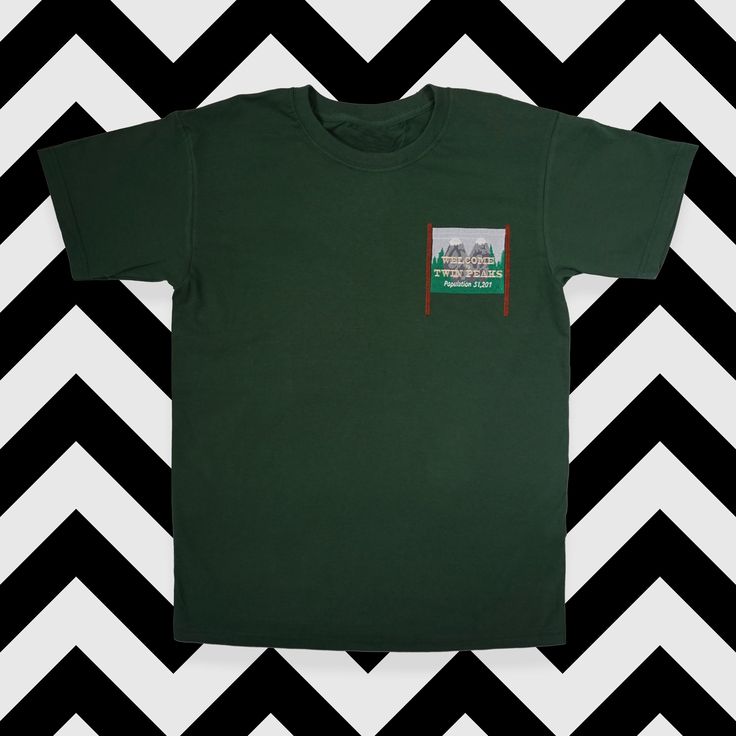 'Welcome to Twin Peaks' sign embroidered onto a high quality cotton t-shirt. Embroidered Relaxed Fit T-shirt For Streetwear, Green Embroidered Text Short Sleeve T-shirt, Cotton T-shirt With Embroidered Graphics, Crew Neck, Graphic Tee With Embroidered Logo, Cotton T-shirt With Embroidered Graphics, Casual Green T-shirt With Embroidered Logo, Cotton Crew Neck Top With Embroidered Patch, Graphic Tee With Embroidered Logo And Short Sleeves, Embroidered Green Tops For Streetwear