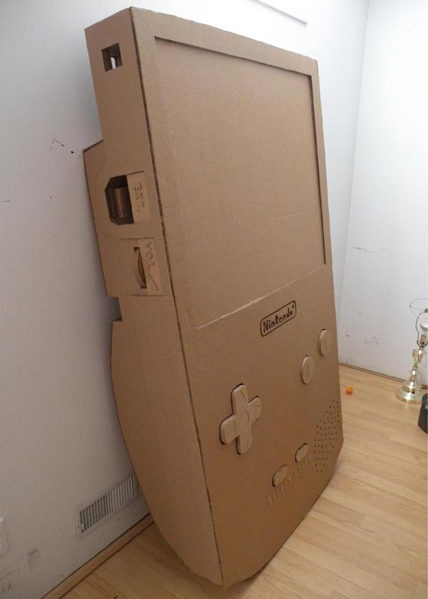 an old nintendo game console sitting on top of a hard wood floor next to a white wall