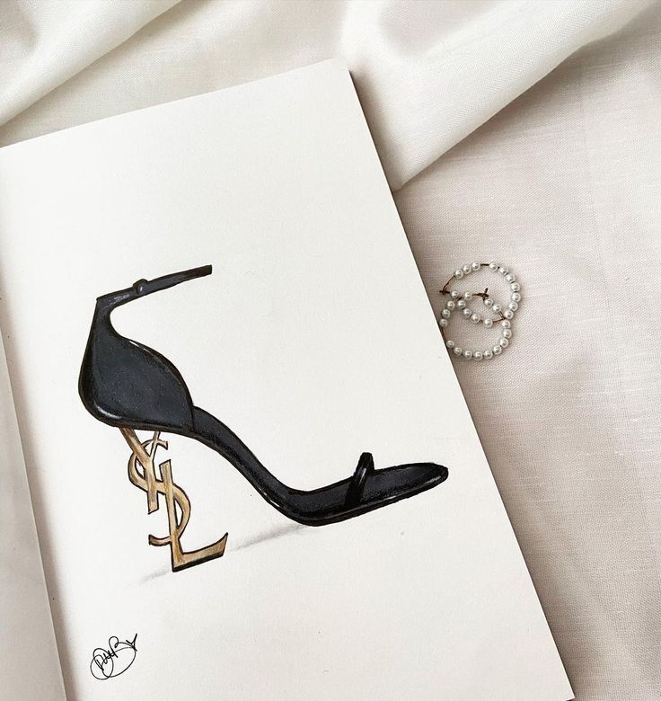 a drawing of a high heeled shoe on top of a white sheet next to a pair of earrings