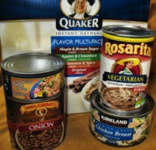 three containers of food are sitting next to each other on a table in front of a sign