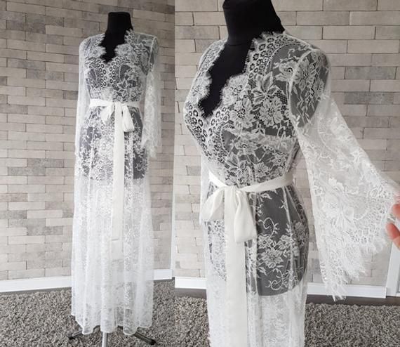 Off-white luxurious wedding robe, to add a perfect touch to your perfect and unique day. Only high quality fabrics and high finishing used for making the robe as neat as it can be. Please find the wedding robes collection here https://www.etsy.com/shop/LidiasBoutiqueDesign?ref=seller-platform-mcnav&section_id=25023222. For wedding dresses, please access https://www.etsy.com/shop/LidiasBoutiqueDesign?ref=seller-platform-mcnav§ion_id=23157290. For wedding tops and boleros, please access https: Feminine Lace Gown With Delicate Details, Elegant Lace Bridal Robe, Elegant Lace Bride's Robe, Delicate Lace Robe For Wedding Night, Lace Wedding Night Robe With Lace Sleeves, Feminine Lace Wedding Robe, Feminine Wedding Gown With Lace Trim, Fitted Lace Wedding Robe, Feminine Lace Robe For Wedding Night