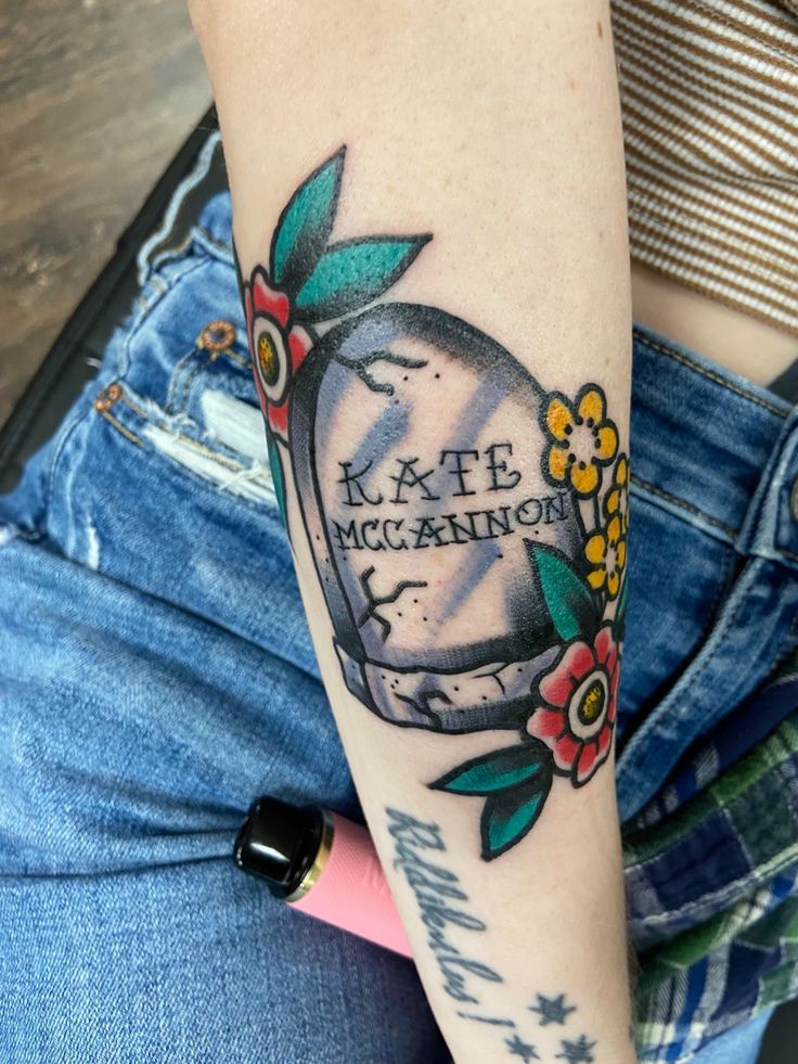 A headstone with flowers. The headstone reads “Kate McCannon” Colter Wall Tattoo Ideas, Western Traditional Tattoo Sleeve, Waylon Tattoo, Colter Wall Tattoo, Waylon Jennings Tattoo, Mama Tried Tattoo, Cody Johnson Tattoo, Mmm Chezburger, Kate Mccannon