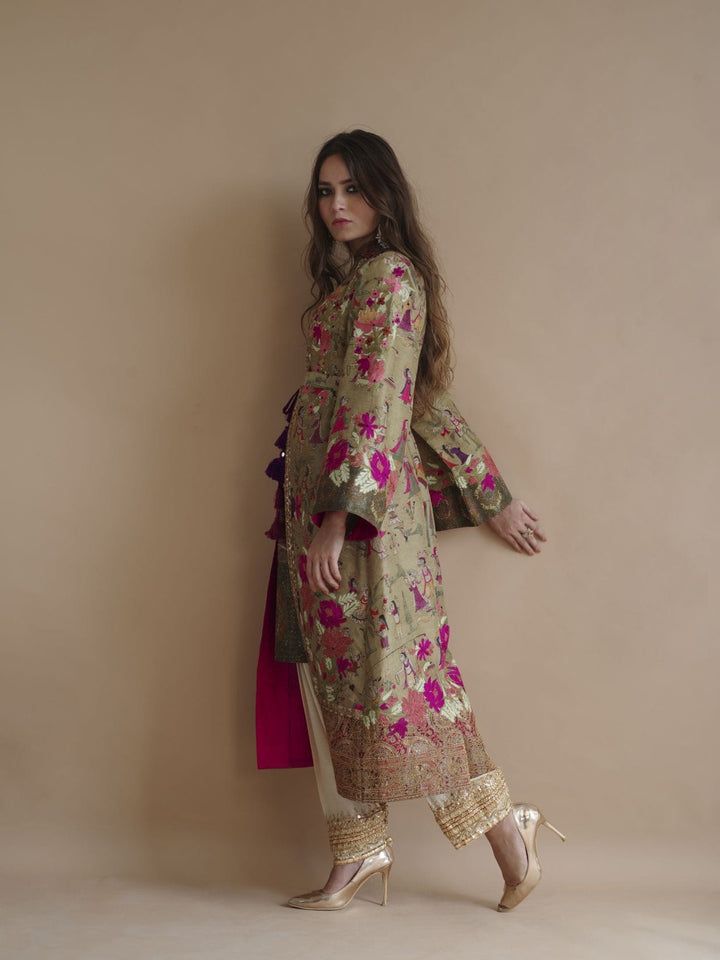 Style Digitally printed pure raw silk inspired by mughal miniatures styled as long front open coat with printed inner. Hand-worked colored aar floral motifs on galla, front and sleeves border. Gold tilla outlines on front border enhancing print. edging of hand-worked pattis in antique sequence and beads and resham flow Open Coat, Plain Pants, Embroidered Pants, Silk Shawl, Indian Designer Outfits, Fabric Belt, Floral Motifs, Raw Silk, Designer Collection