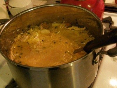 a pot filled with food sitting on top of a stove