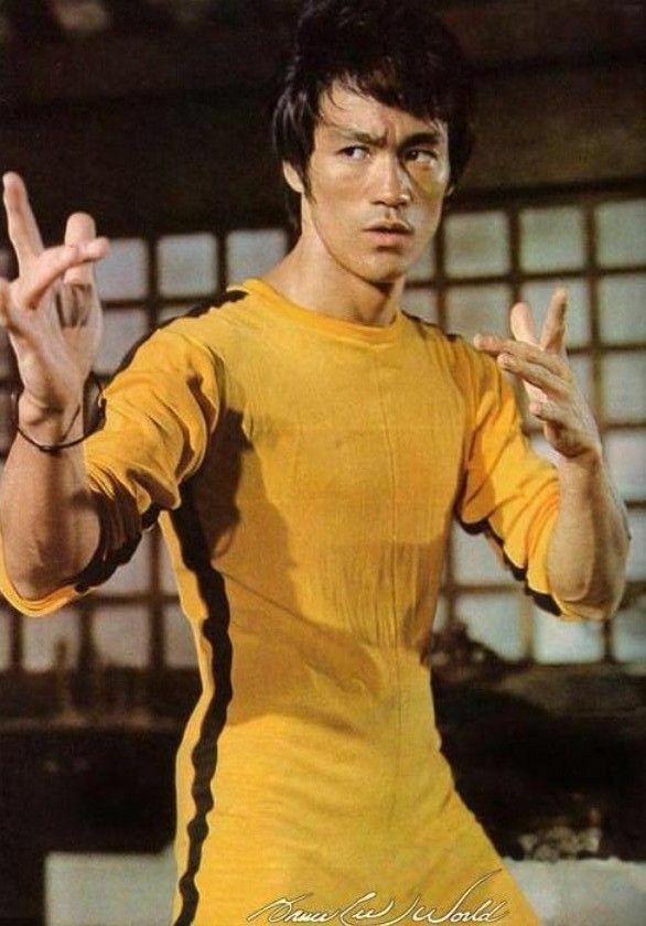 a man in yellow shirt holding up two fingers