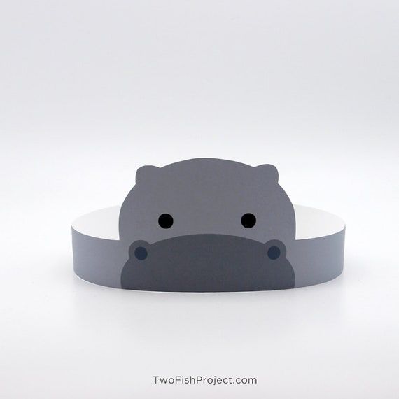 a hippopotamus headband is shown in grey and white with black eyes