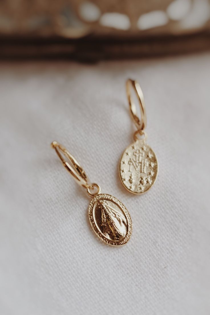 Gold filled 925 sterling silver stamped Mama Mary Miraculous Medal earrings. Dangling from secure sterling silver hoops for easy wear, the Miraculous Medals are solid and double sided. 🤍🕊️ Silver 14k Gold-filled Tarnish Resistant Huggie Earrings, Silver 14k Gold Filled Tarnish-resistant Huggie Earrings, 14k Gold-filled Silver Huggie Earrings Tarnish Resistant, Oval Sterling Silver Jewelry Tarnish Resistant, Oval Sterling Silver Tarnish-resistant Jewelry, Silver Tarnish Resistant Hoop Earrings For Jewelry Making, Gift White Gold Tarnish Resistant Hoop Earrings, White Gold Tarnish-resistant Hoop Earrings As Gift, Nickel-free Silver Earrings In 14k Gold