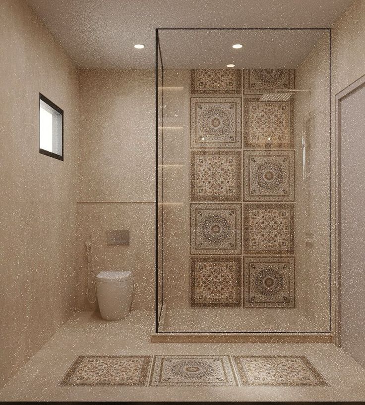 a bathroom with a glass shower door, toilet and tiled flooring on the walls