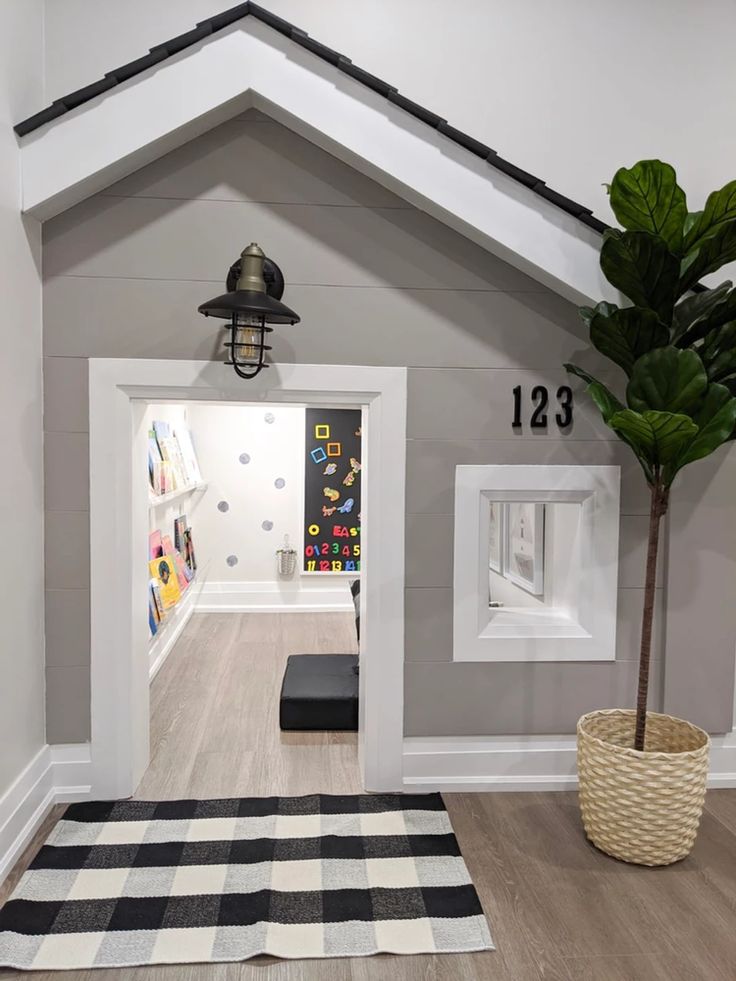 an entry way to a home with white walls and black accents