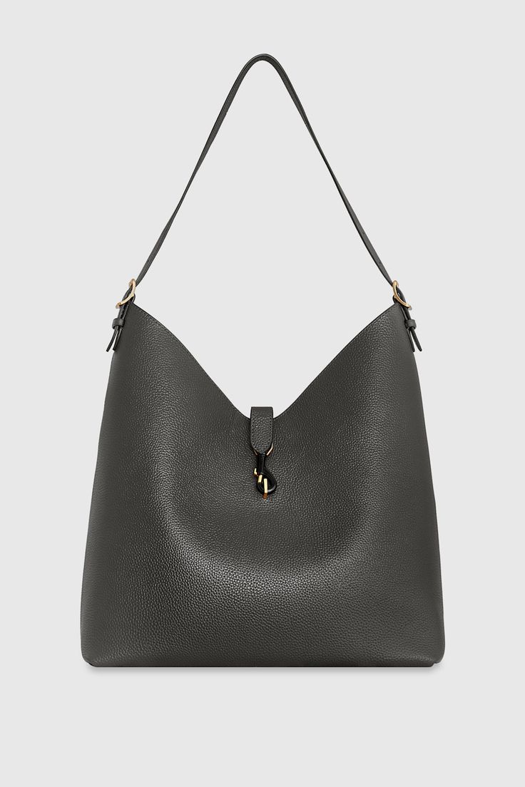 The Megan Hobo is the ideal go-to bag for those seeking effortless style and functionality. Crafted from genuine leather, this spacious hobo is designed to fit all your essentials while maintaining a sleek and modern silhouette. Its magnetic snap closure and antique brass hardware add a touch of sophistication, making it a perfect choice for everyday wear. Style # HH24HMGHOB-SHADOW 100% Genuine Leather Multi Hardware 13" W X 14. 5" H X 6. 25" D 23" Strap Drop Magnetic Snap Closure 1 Back Zip Poc Versatile Tote Bucket Bag With Magnetic Closure, Classic Hobo Tote Bag With Gold-tone Hardware, Classic Hobo Bag With Gold-tone Hardware, Modern Hobo Shoulder Bag With Magnetic Closure, Modern Hobo Tote Bag With Gold-tone Hardware, Versatile Bucket Shoulder Bag With Magnetic Closure, Versatile Everyday Bucket Bag With Magnetic Closure, Everyday Bucket Shoulder Bag With Magnetic Closure, Versatile Bucket Bag With Magnetic Closure