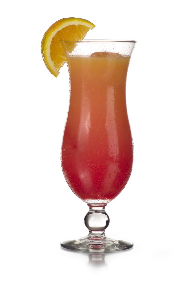 a red drink in a glass filled with ice and garnished with a lemon wedge