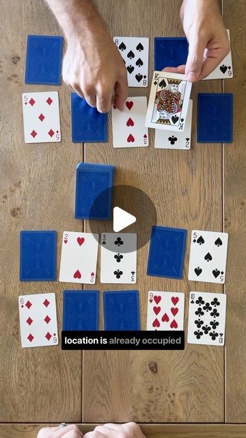 two hands playing cards on a wooden table with the words location is already occupied above them