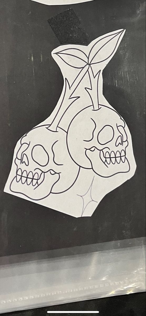 a black and white drawing of two skulls