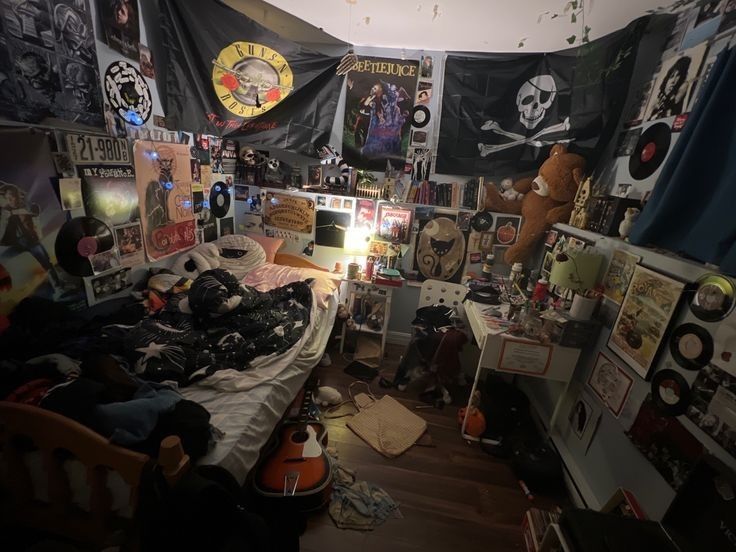 a room filled with lots of clutter and pictures on the walls, including posters