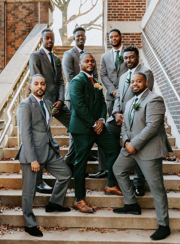 a group of men in suits standing on steps