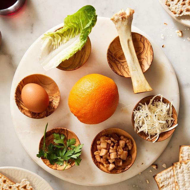 an assortment of food on a plate with crackers and oranges next to it