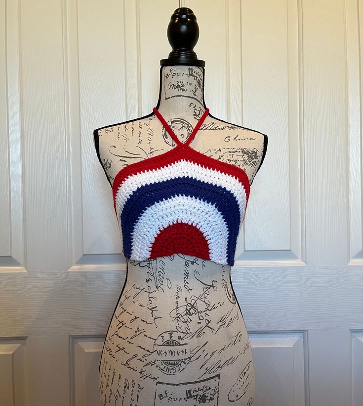 a mannequin wearing a red, white and blue crochet halter top