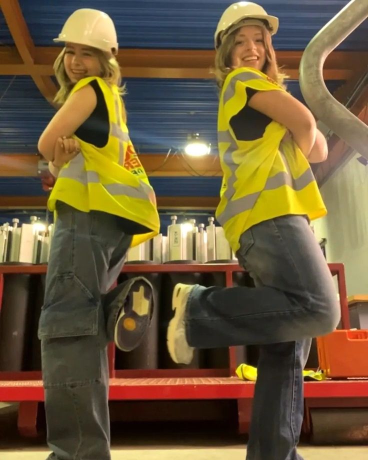 two women in yellow vests and hard hats