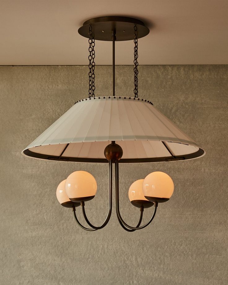 a light fixture with two lamps hanging from it's sides and one lamp on the other side