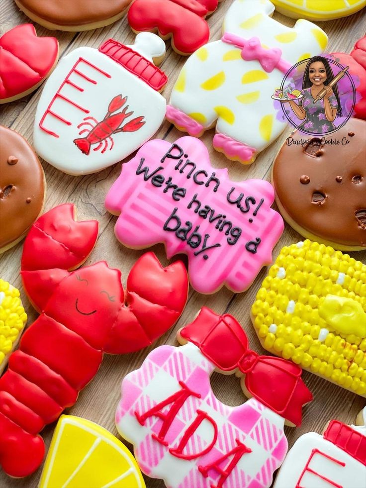 decorated cookies with words and images on them are arranged in the shape of lobsters