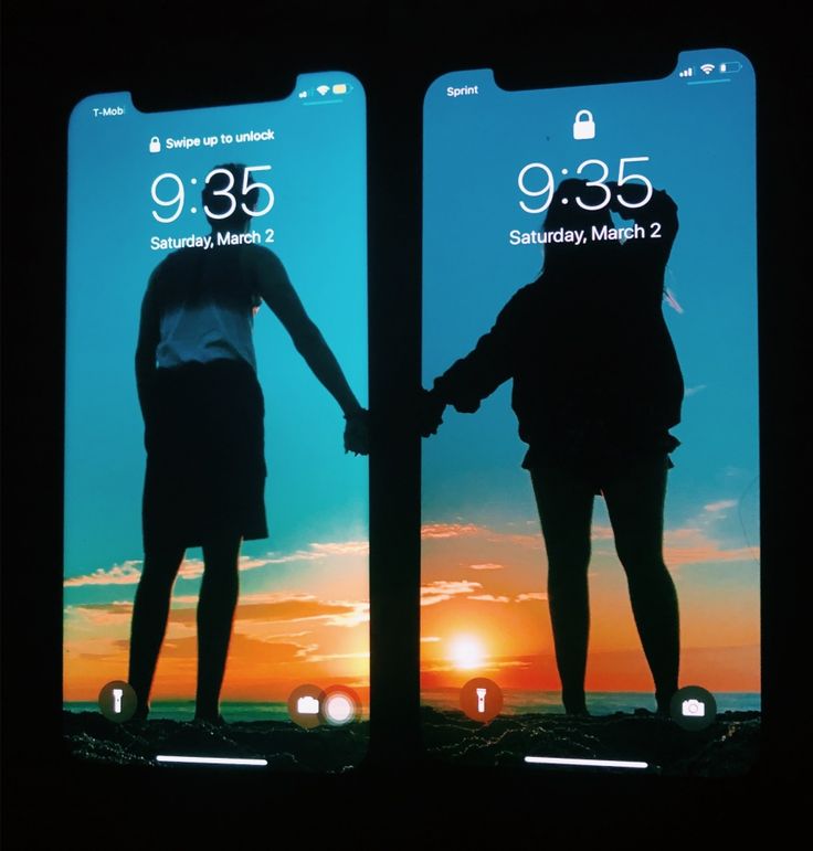 two iphones showing the same image as they are being held by each other with their hands