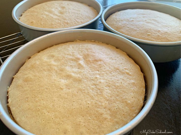 three pans filled with cake batter sitting on top of a counter