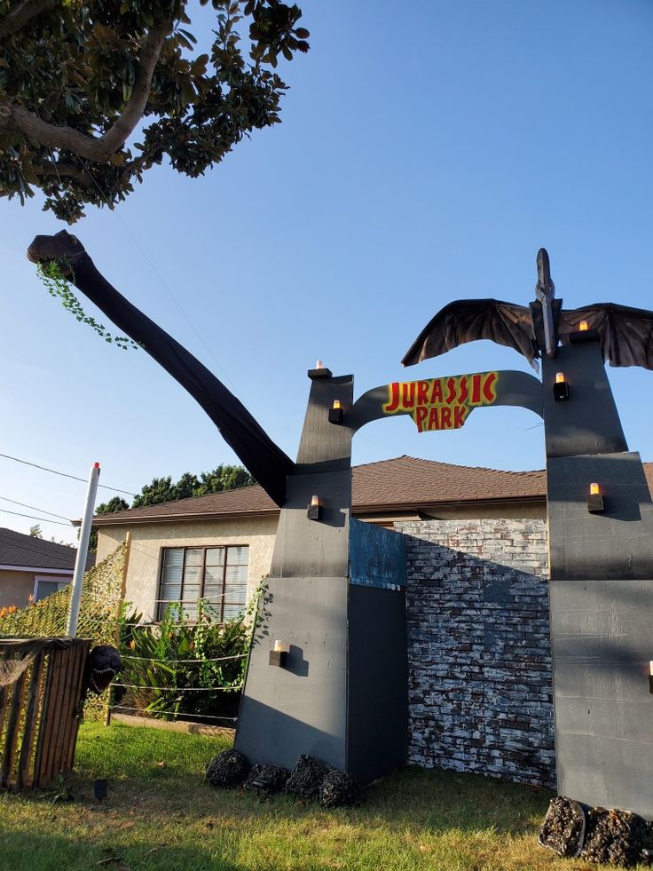 the entrance to an amusement park with a statue of a dragon on it's back