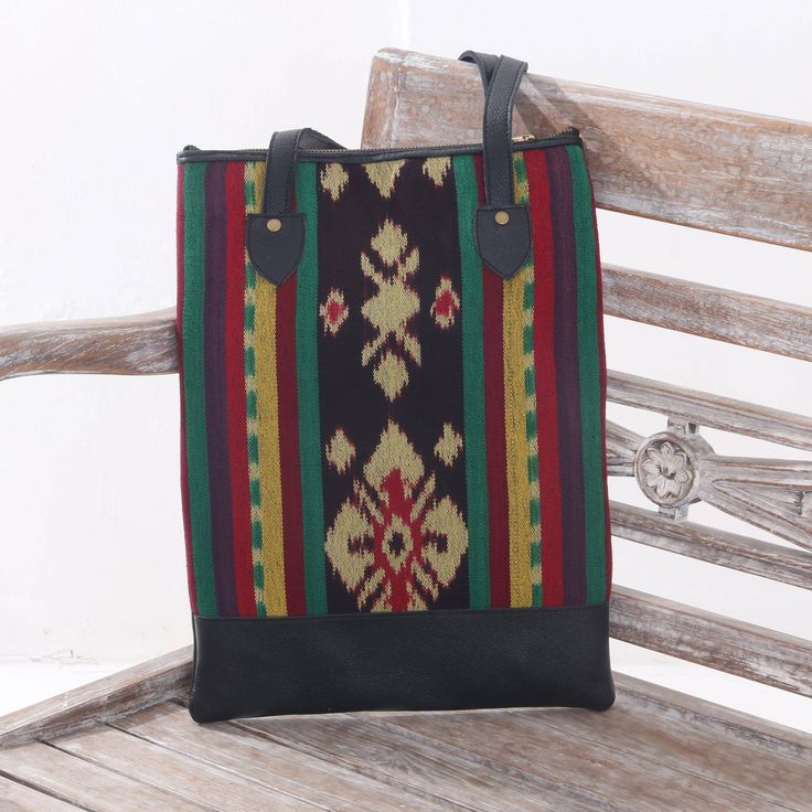 Shintamie Suryaputri brings to life the sights and sounds of the city of Jepara in this stylish shoulder bag. A colorful cotton panel features traditional Javanese designs and is adorned with leather accents. The cotton base is replete with ikat motifs where the threads are tie-dyed before they are placed on the loom. Three interior pockets â one with a zipper â keep small items in place. Traditional Black Travel Bag, Traditional Black Rectangular Shoulder Bag, Multicolor Bags With Traditional Patterns For Everyday Use, Traditional Multicolor Shoulder Bag For Everyday Use, Traditional Tote Canvas Bag For Everyday Use, Rectangular Bag With Woven Motifs For Daily Use, Rectangular Bags With Woven Motifs For Daily Use, Traditional Tote Shoulder Bag For Travel, Traditional Style Tote Shoulder Bag For Travel