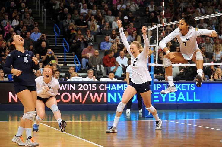 the volleyball players are jumping up to hit the ball