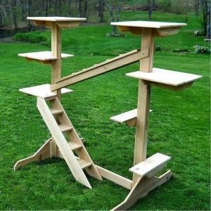 a wooden table sitting on top of a lush green field