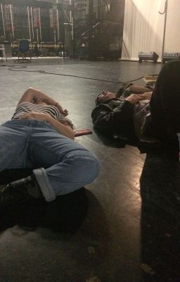 three people laying on the floor in an empty room