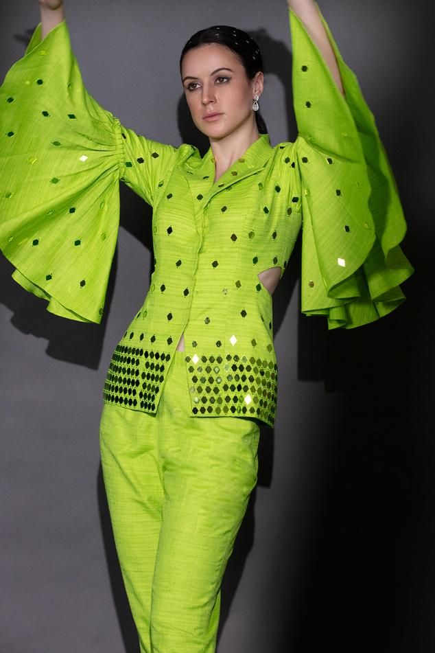 Neon green matka silk jacket with laser-cut acrylic glass and beaded embroidery. Comes with pant.
Components: 2
Pattern: Embroidered
Type Of Work: Laser-cut acrylic glass, Beads
Neckline: Lapel collar
Sleeve Type: Bell Sleeves
Fabric: Matka silk
Color: Green
Other Details: 
Length :
Jacket : 25 inches
Pant : 36 inches
Closure : Jacket - Front buttons
Occasion: Party - Aza Fashions Lapel Jacket, Beaded Neckline, Types Of Work, Laser Cut Acrylic, Silk Jacket, Embroidered Jacket, Pant Set, Embroidered Silk, Set For Women