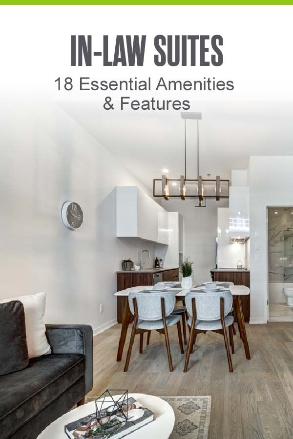 a living room filled with furniture and a dining table in front of a white wall