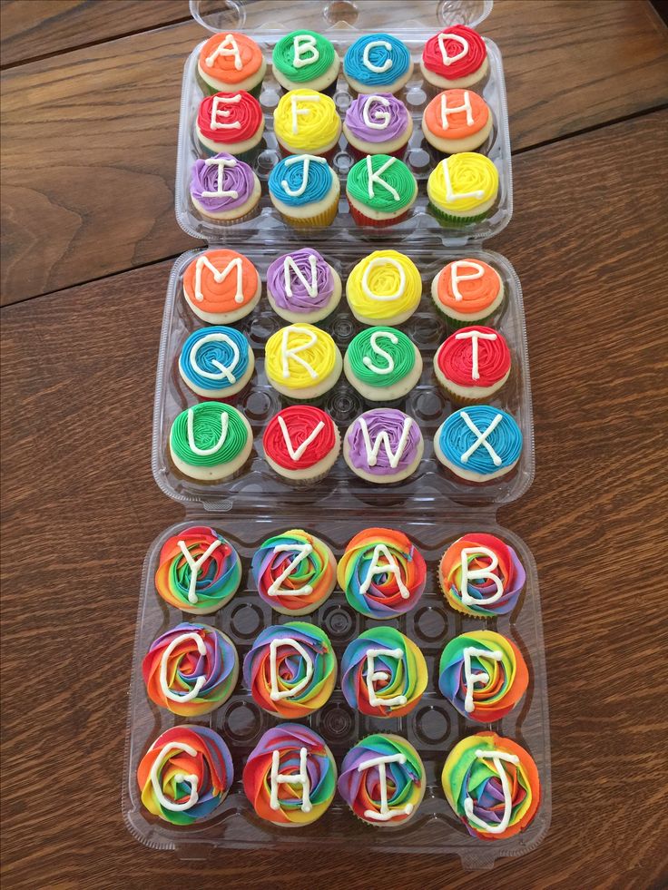 cupcakes in plastic containers with letters and numbers on them