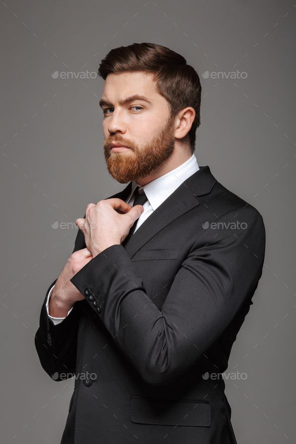 a man in a suit and tie posing for the camera - stock photo - images