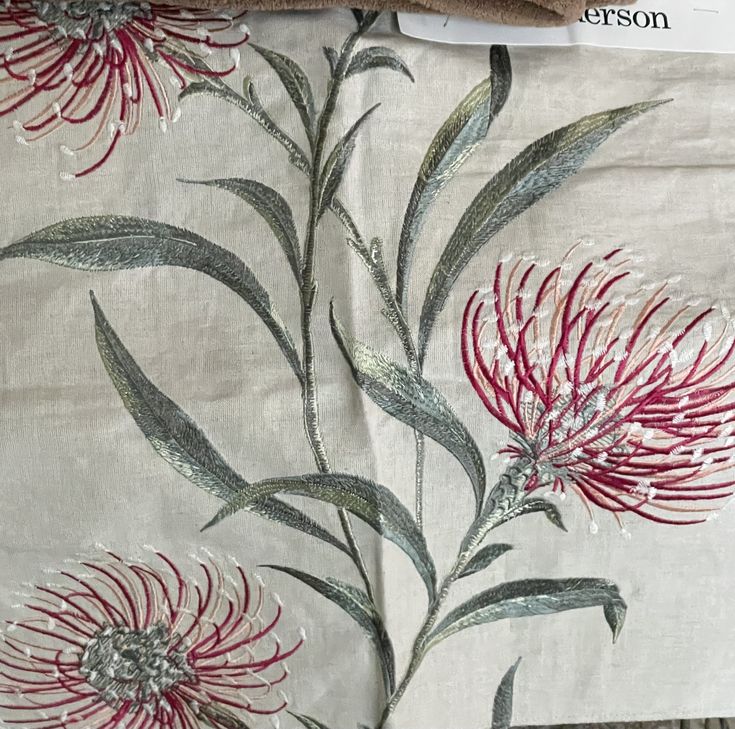 an image of some flowers on a table cloth with scissors and paper next to it