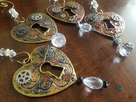 three pieces of jewelry sitting on top of a wooden table