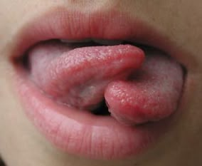 a woman's tongue sticking out into the air