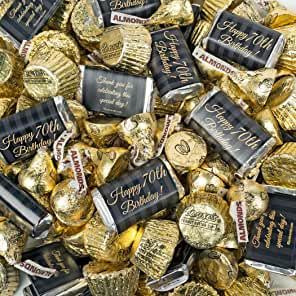 a pile of gold foiled chocolates with happy birthday messages on them in black and white