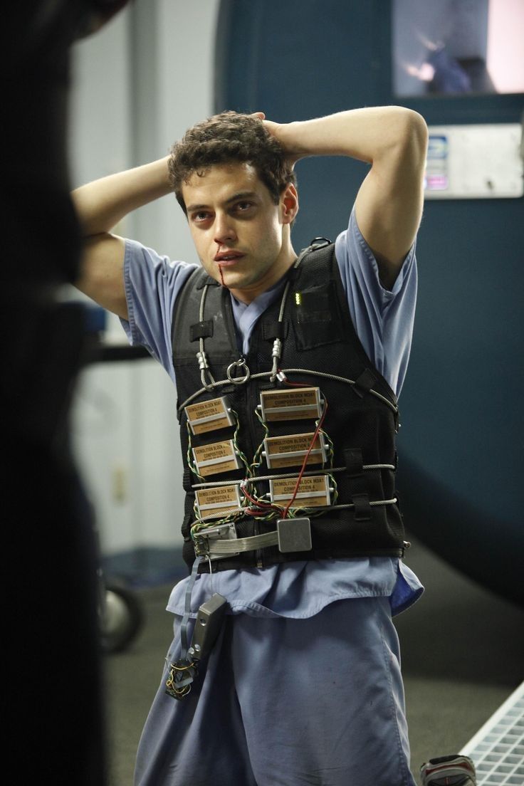 a young man is holding his head while wearing an electronic device