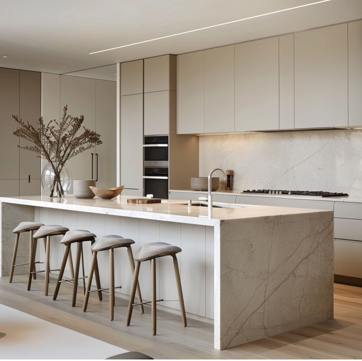 a kitchen with marble counter tops and stools next to an island in the middle