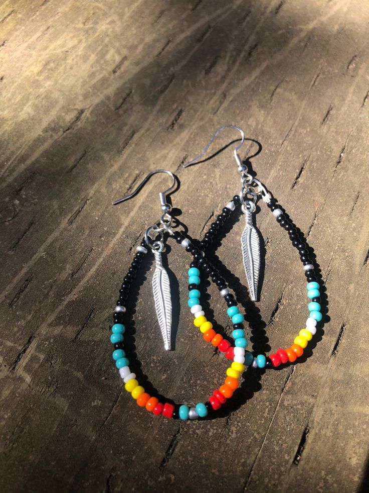 Tribal/native American beaded earrings, with feather charm. Black Teardrop Bohemian Jewelry, Southwestern Style Beaded Dangle Earrings For Festival, Southwestern Dangle Beaded Earrings For Festivals, Southwestern Style Dangle Beaded Earrings For Festivals, Southwestern Dangle Beaded Earrings, Black Bohemian Hoop Earrings For Festivals, Bohemian Black Teardrop Beaded Earrings, Bohemian Black Beaded Dangle Jewelry, Black Southwestern Dangle Earrings