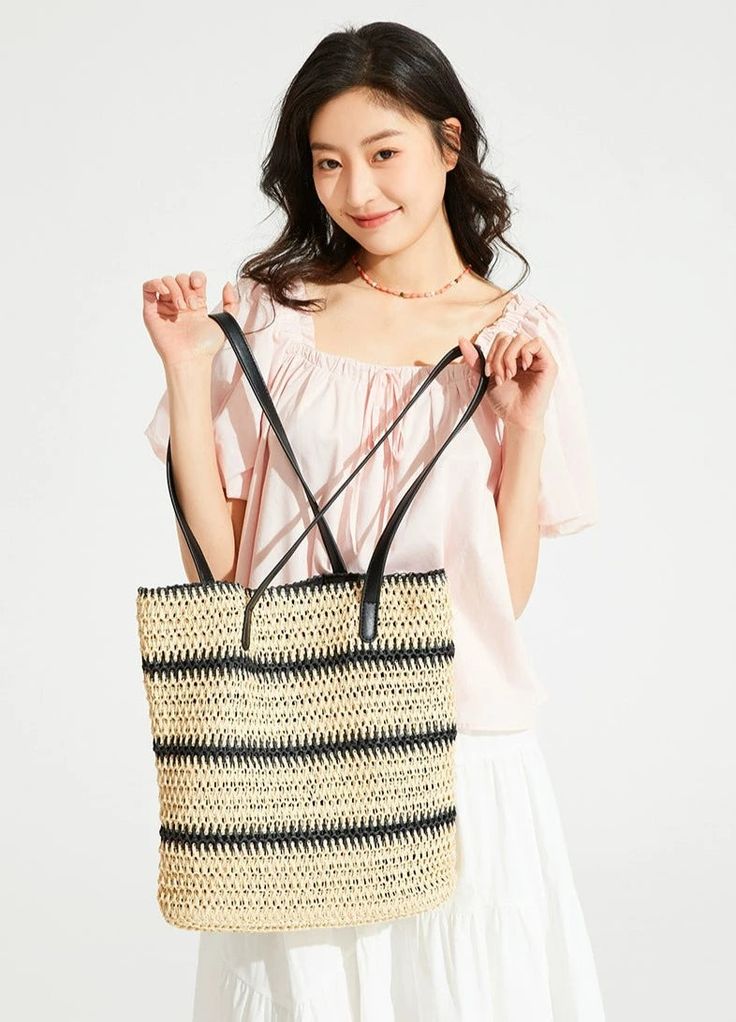 Make a statement with our Woven Striped Tote with Leather Handles, perfect for an effortlessly stylish look. With its durable cellulose material and trendy color-blocking design, this tote boasts a chic vertical square shape and features a practical internal phone pocket. The soft texture and striped pattern add a touch of sophistication, while the leather handles ensure comfortable carrying, making it an ideal accessory for your daily endeavors or leisure activities. Take this versatile tote to Versatile Rectangular Straw Bag For Daily Use, Chic Large Capacity Straw Bag For Shopping, Spring Rectangular Bucket Bag For Daily Use, Trendy Rectangular Bucket Bag For Shopping, Square Bucket Bag With Braided Handles, Summer Black Bucket Bag For Shopping, Rectangular Summer Shoulder Bag For Shopping, Chic Large Capacity Rectangular Beach Bag, Summer Style Rectangular Shopping Shoulder Bag