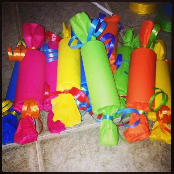 many different colored bags are on the floor next to each other with ribbons tied around them