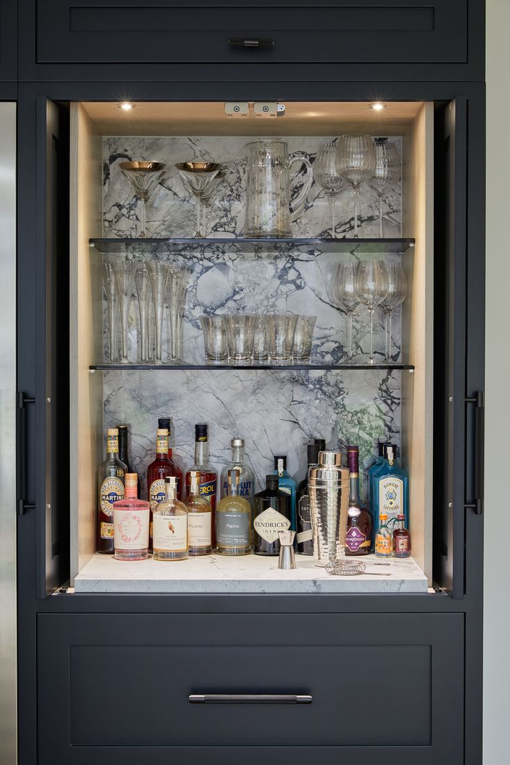 a cabinet filled with liquor bottles and glasses