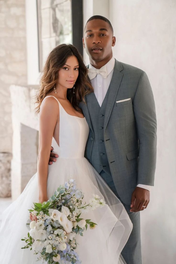 a bride and groom pose for a wedding photo