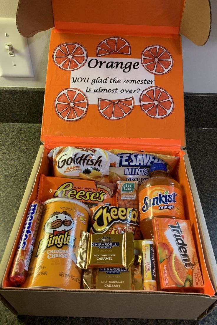 an orange box filled with lots of different types of snacks