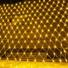 a fence covered in lights on the ground